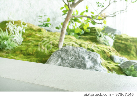 Empty natural stone concrete podium for product packaging. Cosmetics background with green leaves. Empty natural stone concrete podium for product packaging. Cosmetics background with green leaves. 97867146