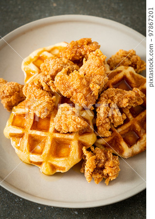 fried chicken waffle with honey or maple syrup fried chicken waffle with honey or maple syrup 97867201