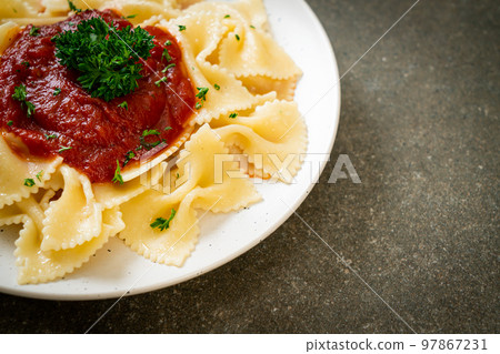 farfalle pasta in tomato sauce with parsley farfalle pasta in tomato sauce with parsley 97867231