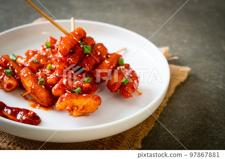 deep fried Korean rice cake (Tteokbokki) skewered with spicy sauce 97867881