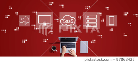 SaaS - software as a service concept with person working with laptop SaaS - software as a service concept with person working with laptop 97868425