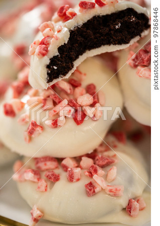 Freshly baked peppermint white chocolate cookies on a white plate. 97868446