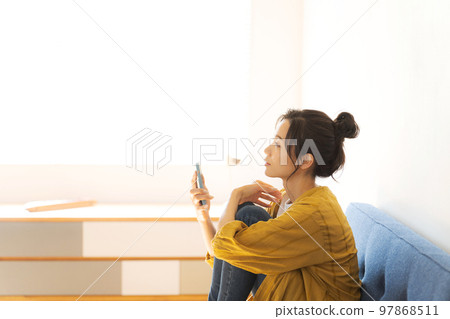 A woman watching a smartphone A woman watching a smartphone 97868511