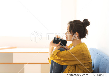 A woman watching a smartphone A woman watching a smartphone 97868512