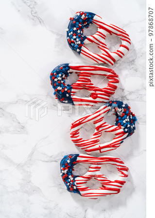 American flag. Red, white, and blue chocolate-covered pretzel twists. 97868707