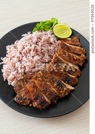 spicy grilled Jamaican jerk chicken with rice 97869026