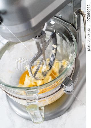 Lemon wedge cookies with lemon glaze. Mixing ingredients in kitchen mixer to bake lemon wedge cookies with lemon glaze. 97869031