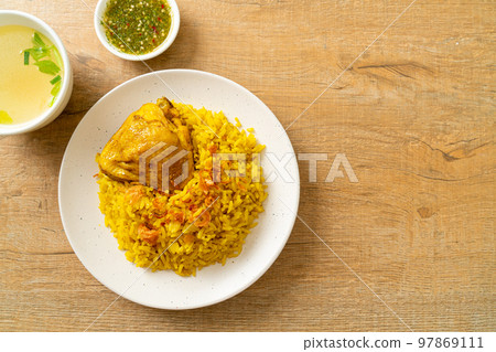 Chicken Biryani or Curried rice and chicken - Thai-Muslim version of Indian biryani, with fragrant yellow rice and chicken Chicken Biryani or Curried rice and chicken - Thai-Muslim version of Indian biryani, with fragrant yellow rice and chicken 97869111