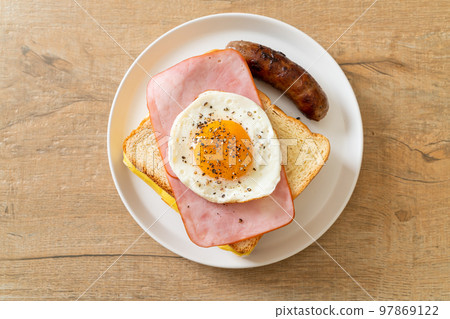 bread toasted cheese topped ham and fried egg with pork sausage 97869122