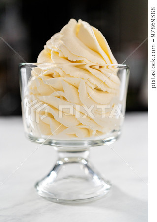Homemade whipped cream in a class ice cream bowl. Homemade whipped cream in a class ice cream bowl. 97869388