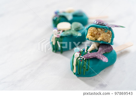 Sliced cakesicles with a chocolate mermaid tail. 97869543