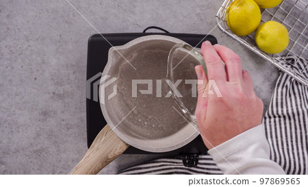 Flat lay. Cooking cake syrup for cake in a saucepan. 97869565