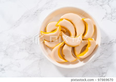 Lemon wedge cookies with lemon glaze. Freshly baked lemon wedge cookies with lemon glaze on a white plate. 97869670