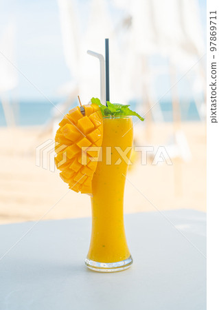 mango smoothies with sea beach background mango smoothies with sea beach background 97869711