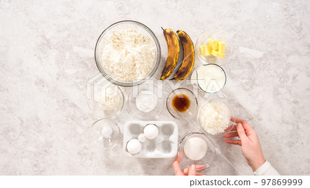 Flat lay. Step by step. Measured ingredients in glass mixing bowls to prepare coconut banana pancakes for breakfast. Flat lay. Step by step. Measured ingredients in glass mixing bowls to prepare coconut banana pancakes for breakfast. 97869999
