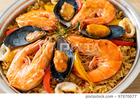 Seafood Paella with prawns, clams, mussels on saffron rice Seafood Paella with prawns, clams, mussels on saffron rice 97870077