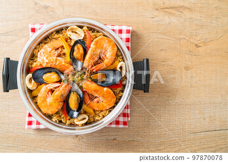 Seafood Paella with prawns, clams, mussels on saffron rice 97870078