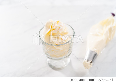 Homemade whipped cream in a class ice cream bowl. Homemade whipped cream in a class ice cream bowl. 97870271