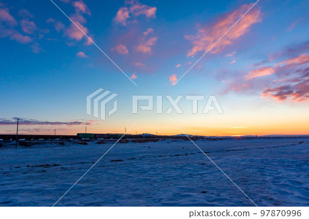 A train running through a snowy field and the sky approaching dawn in Mongolia in the middle of winter A train running through a snowy field and the sky approaching dawn in Mongolia in the middle of winter 97870996