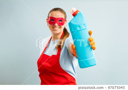 Woman in red mask, rubber gloves and apron holding cleaning agent bottle Woman in red mask, rubber gloves and apron holding cleaning agent bottle 97875045