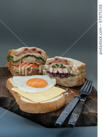 Homemade Sandwichs stuffed Ham, Cheese, Crab stick and vegetables with Cheese and Fried egg on  Bread. 97875108