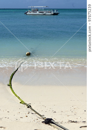 Buoy and boat on the beach SAIPAN 97875239