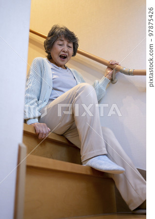 Senior woman falling down the stairs 97875426
