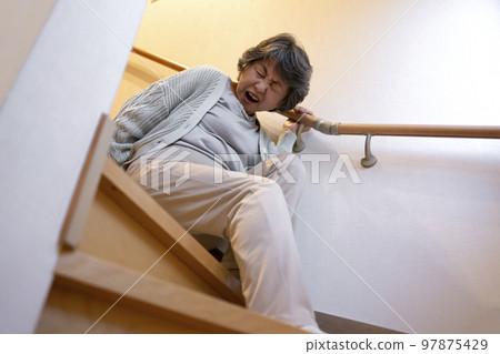 Senior woman falling down the stairs 97875429