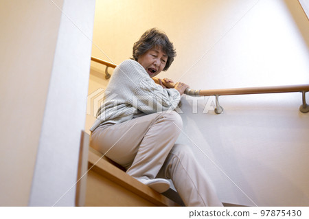 Senior woman falling down the stairs 97875430