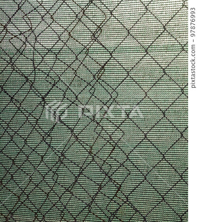 Metal mesh fence and synthetic fabric. 97876993