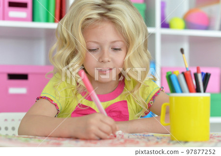 girl drawing picture at desk at home 97877252