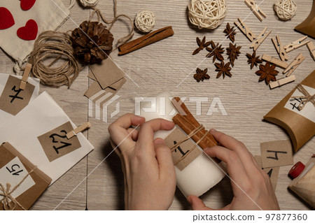 Unrecognizable young woman paint numbers on candles. Female making homemade advent calendar Made with your own hands step by step DIY crafts do it yourself. Preparation to christmas concept. Seasonal Unrecognizable young woman paint numbers on candles. Female making homemade advent calendar Made with your own hands step by step DIY crafts do it yourself. Preparation to christmas concept. Seasonal 97877360