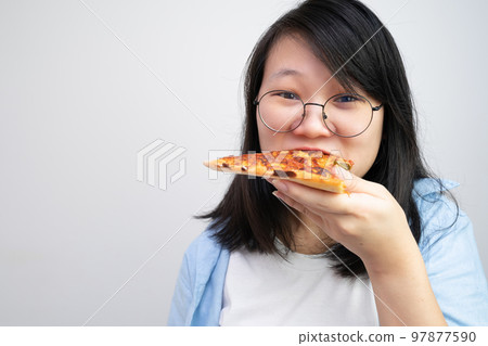 Happy glasses Asian young woman eat Pizza on white background. Happy glasses Asian young woman eat Pizza on white background. 97877590