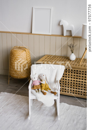 Homemade children's toys on a chair in the interior and decor of a children's room 97877756