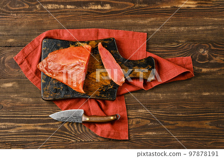 Top view of smoked turkey breast on wooden cutting board Top view of smoked turkey breast on wooden cutting board 97878191
