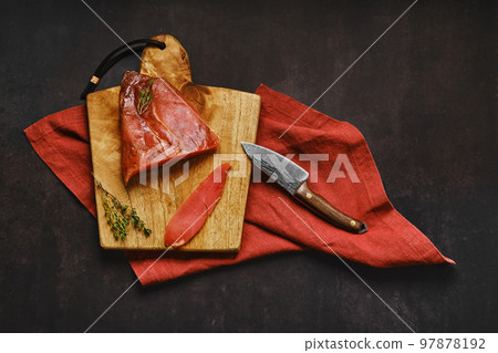 Top view of smoked turkey breast on wooden cutting board with place for text Top view of smoked turkey breast on wooden cutting board with place for text 97878192