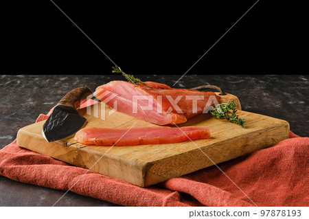 Smoked turkey breast on wooden cutting board (photo with full depth of field) Smoked turkey breast on wooden cutting board (photo with full depth of field) 97878193