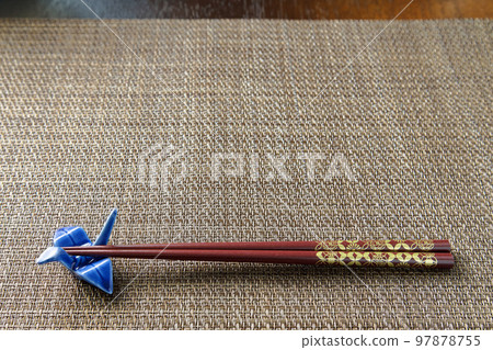 Brown luncheon mat with chopsticks and crane chopstick rest 97878755
