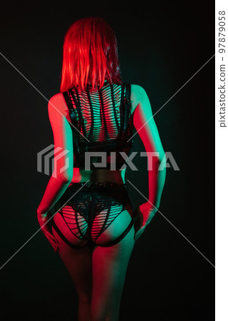 woman with a sexy ass and a slender body with red hair in beautiful erotic underwear with neon light 97879058