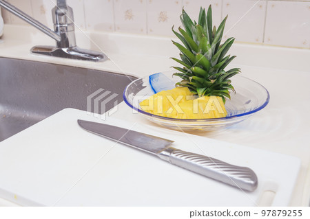 [Complete by placing the cut pineapple on a plate] 97879255