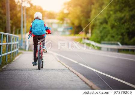 Teenager in the morning hurrying on bicycle to the lesson 97879269