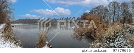 Panoramic image of frozen lake at frosty temperature during sunrise Panoramic image of frozen lake at frosty temperature during sunrise 97879656