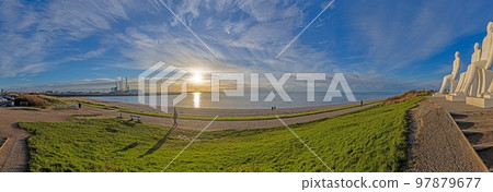 Image of the sculptures of man by the sea in the city of Esbjerg at sunset 97879677