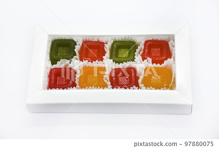 Delicious and juicy marmalade on a white plate. Pieces of fruit marmalade. A sweet snack. Delicious and juicy marmalade on a white plate. Pieces of fruit marmalade. A sweet snack. 97880075