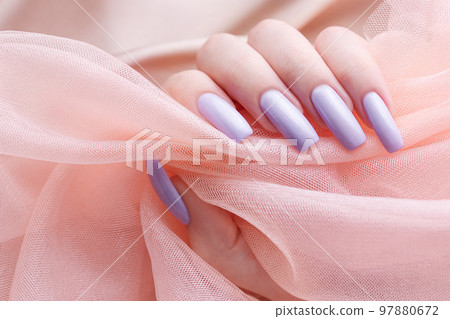 Girl's hands with a soft purple manicure. 97880672