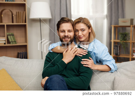 Romantic Couple Embracing Sofa. Happy Couple Relaxing On Couch At Home 97880692