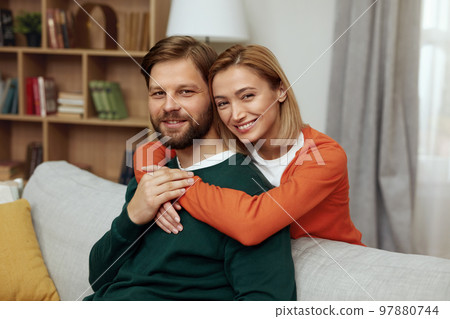 Romantic Couple Embracing Sofa. Happy Couple Relaxing On Couch At Home Romantic Couple Embracing Sofa. Happy Couple Relaxing On Couch At Home 97880744