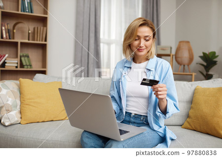 Positive Woman Holding Credit Card. Smiling Woman Paying Online 97880838