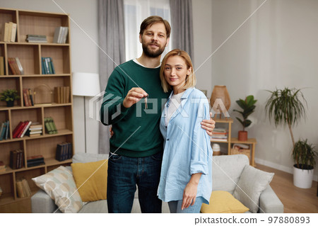 Happy Couple Holding Key. Happy Young Family Holding Key To New Home 97880893