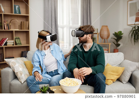 Happy Couple Playing VR Games. Boyfriend And Girlfriend Enjoying Virtual Reality Happy Couple Playing VR Games. Boyfriend And Girlfriend Enjoying Virtual Reality 97880901